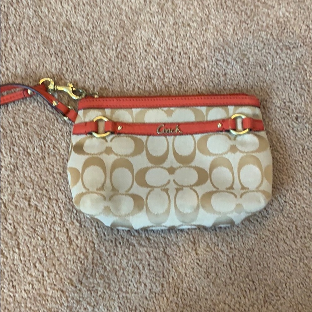 Beige coach clutch with orange zipper